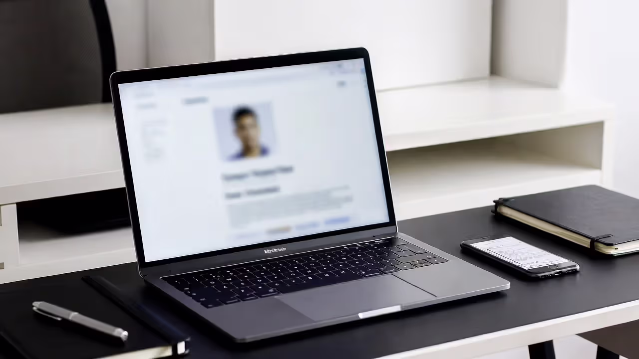 Laptop displaying blurred attorney directory on office desk