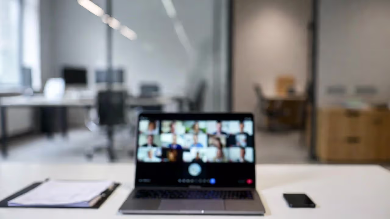 Virtual legal consultation on laptop with documents on desk