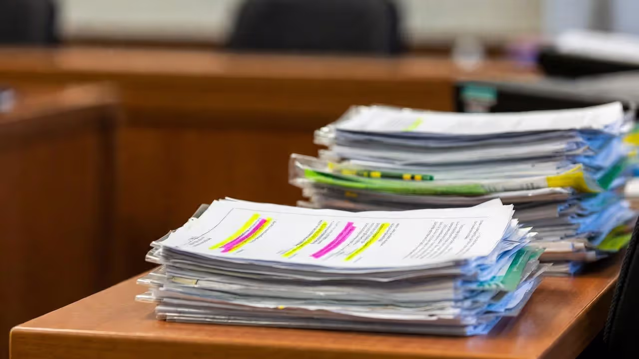 Court documents and a highlighted opinion page on a judge’s bench.