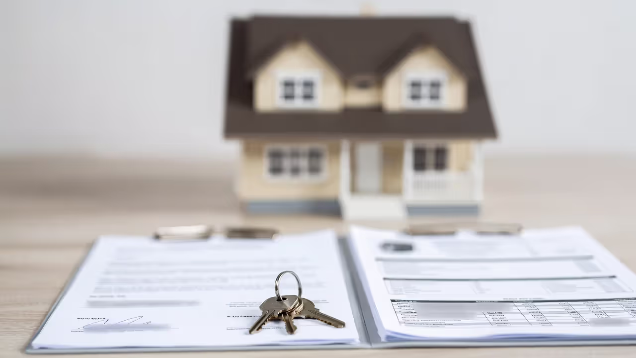 Real estate documents and house keys representing property protection in prenup