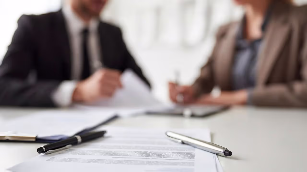 Close-up of business contract with redlined edits on office desk